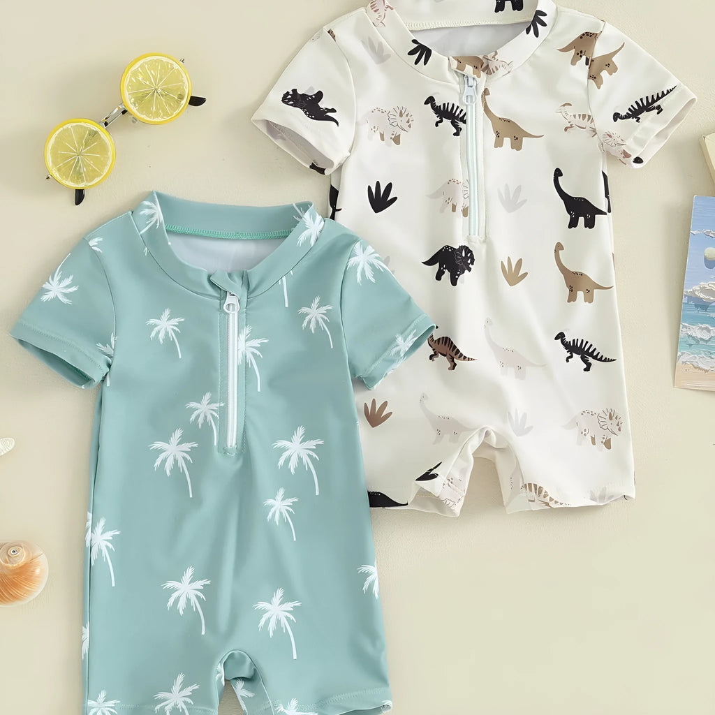 Children's polyester swimsuit in peacock green white coconut tree print and ivory white black coffee dinosaur print, sizes 70-110