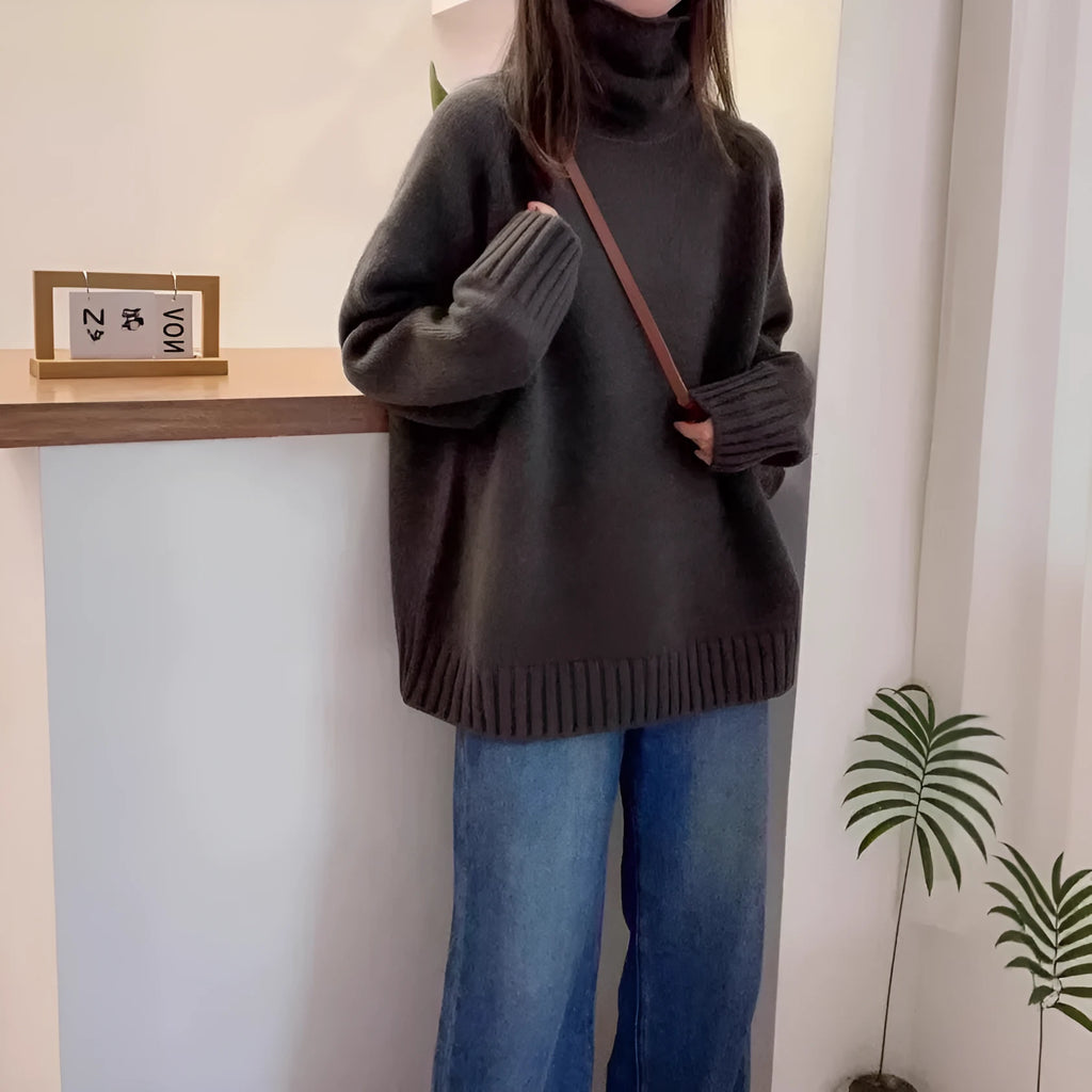 Red women's loose fit turtleneck sweater with a thick knit and curly pile collar on a hanger.
