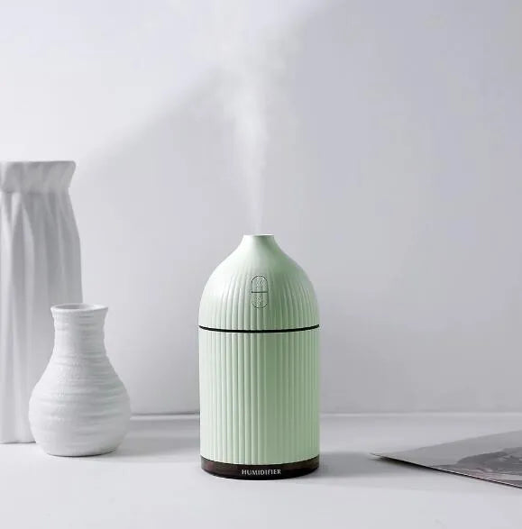 White ultrasonic aromatherapy diffuser and humidifier with LED light and 300ml capacity.