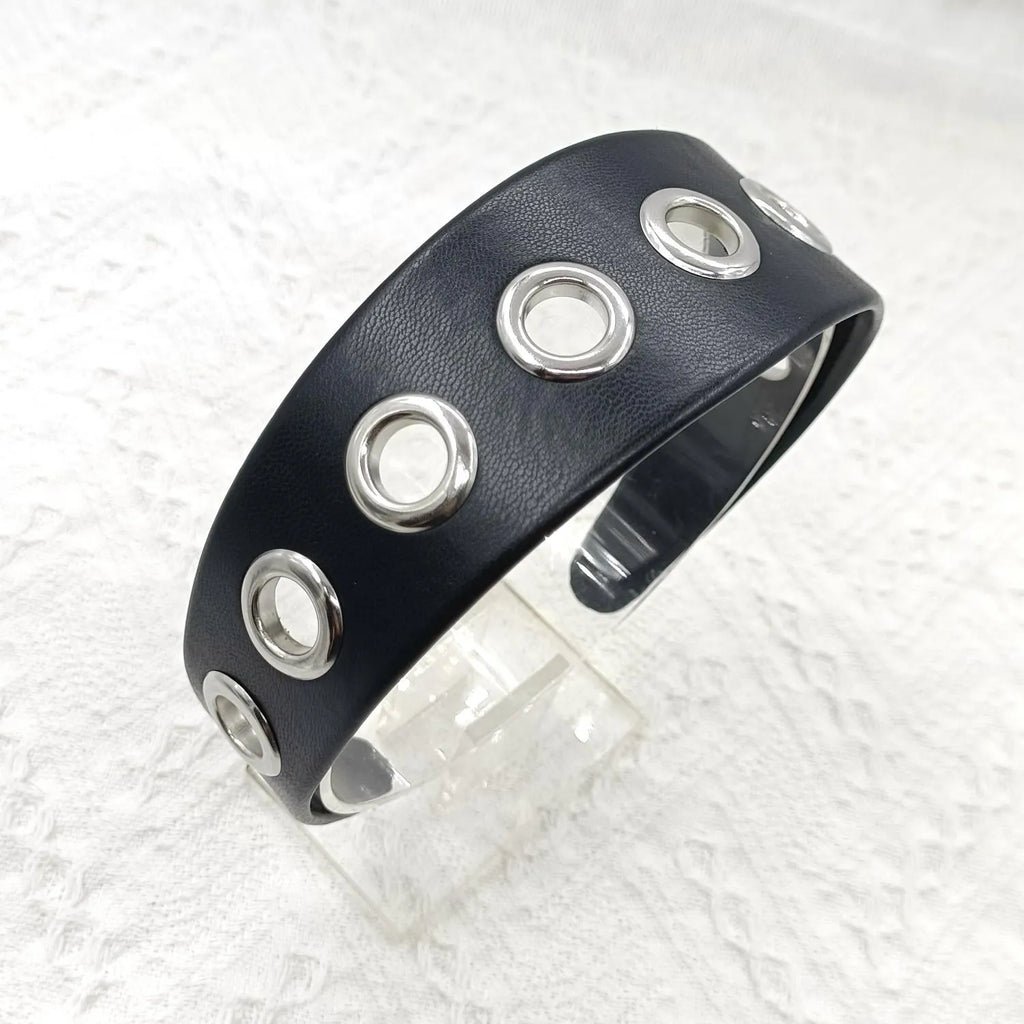 Black faux leather wide version women's headband with round, square, and dotted rivets