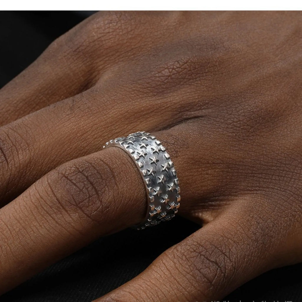 Adjustable opening sterling silver ring with a five-pointed star geometric design.