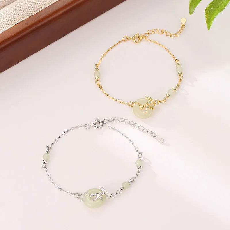 Women's antique style silver bracelet with a peace buckle and safety clasp in gold or silver finish.