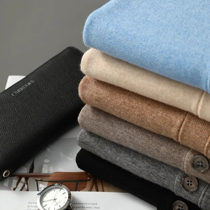 Man wearing a loose beige Andy velvet V-neck cardigan coat with long sleeves