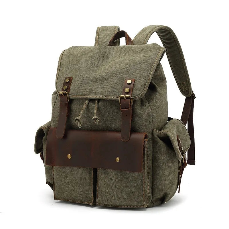 Retro-style canvas backpack in military green with antique bronze hardware, shown with a 16-inch laptop.