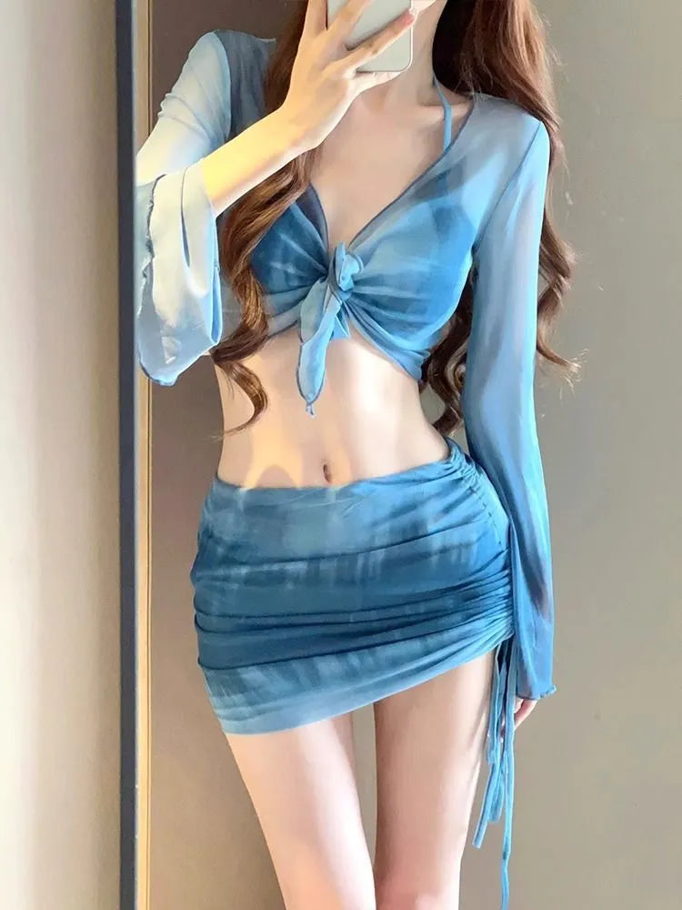 Women's blue high-waist bikini four-piece swimsuit set showing shirt, bra, underwear, and skirt components