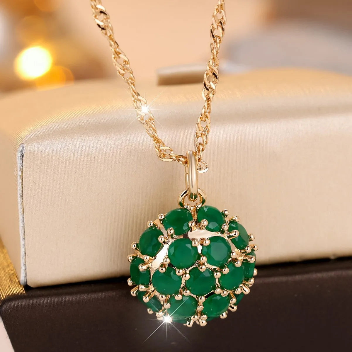 Round emerald and diamond necklace with adjustable chain in champagne gold