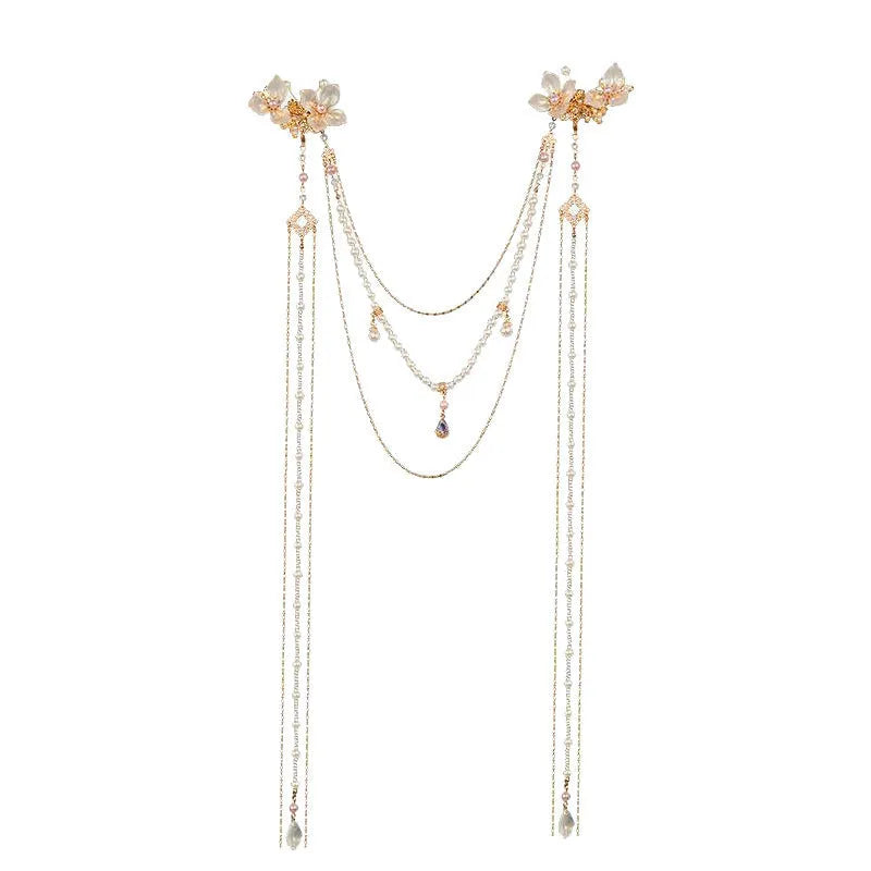 Gold women's hairpin with acrylic pearl flower, long tassels, and diamond-bead grip on a metallic pin.