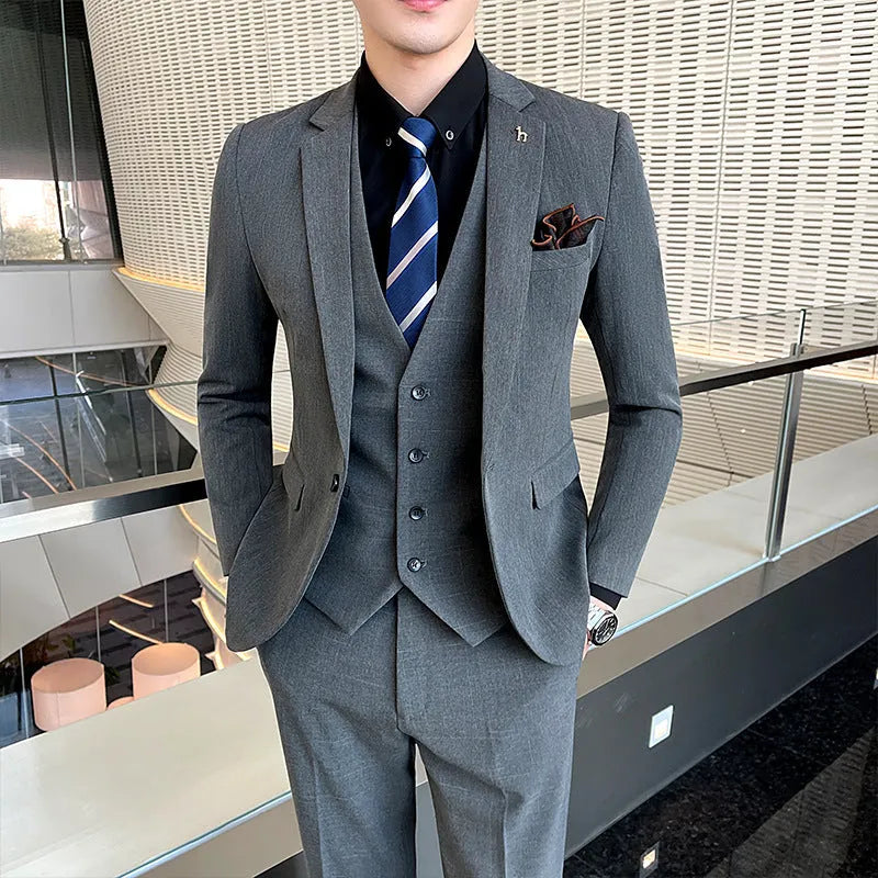 Men's slim fit black business suit jacket and trousers on a hanger.