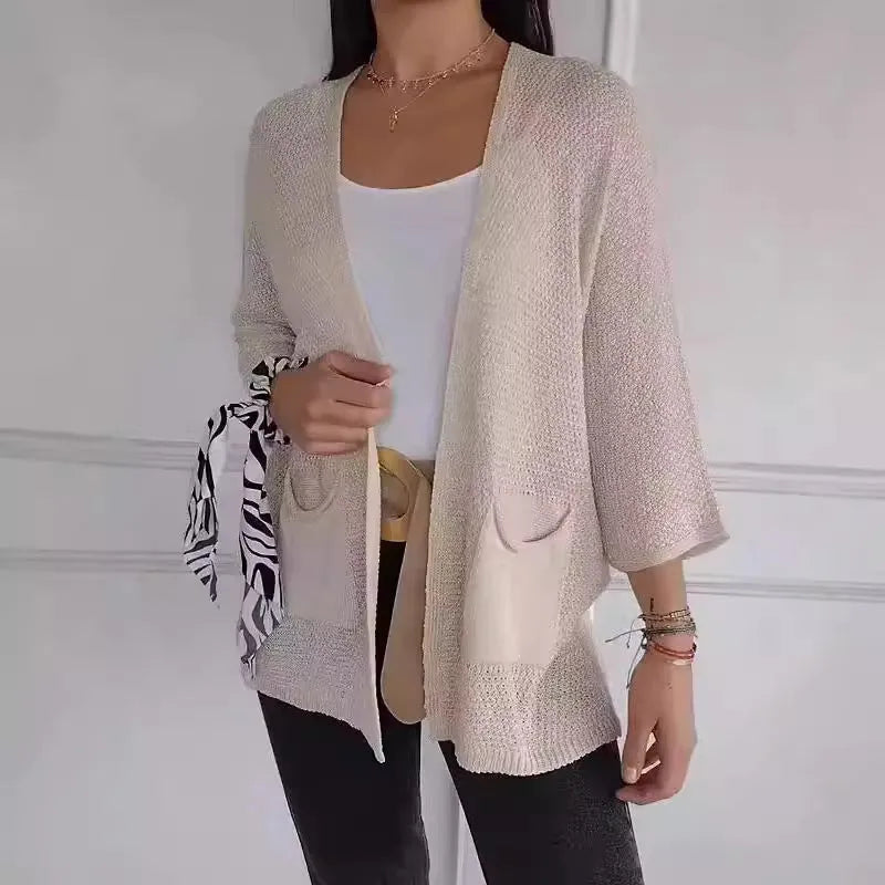 Women's army green waffle texture cardigan coat with nine-quarter sleeves and pockets on a hanger.