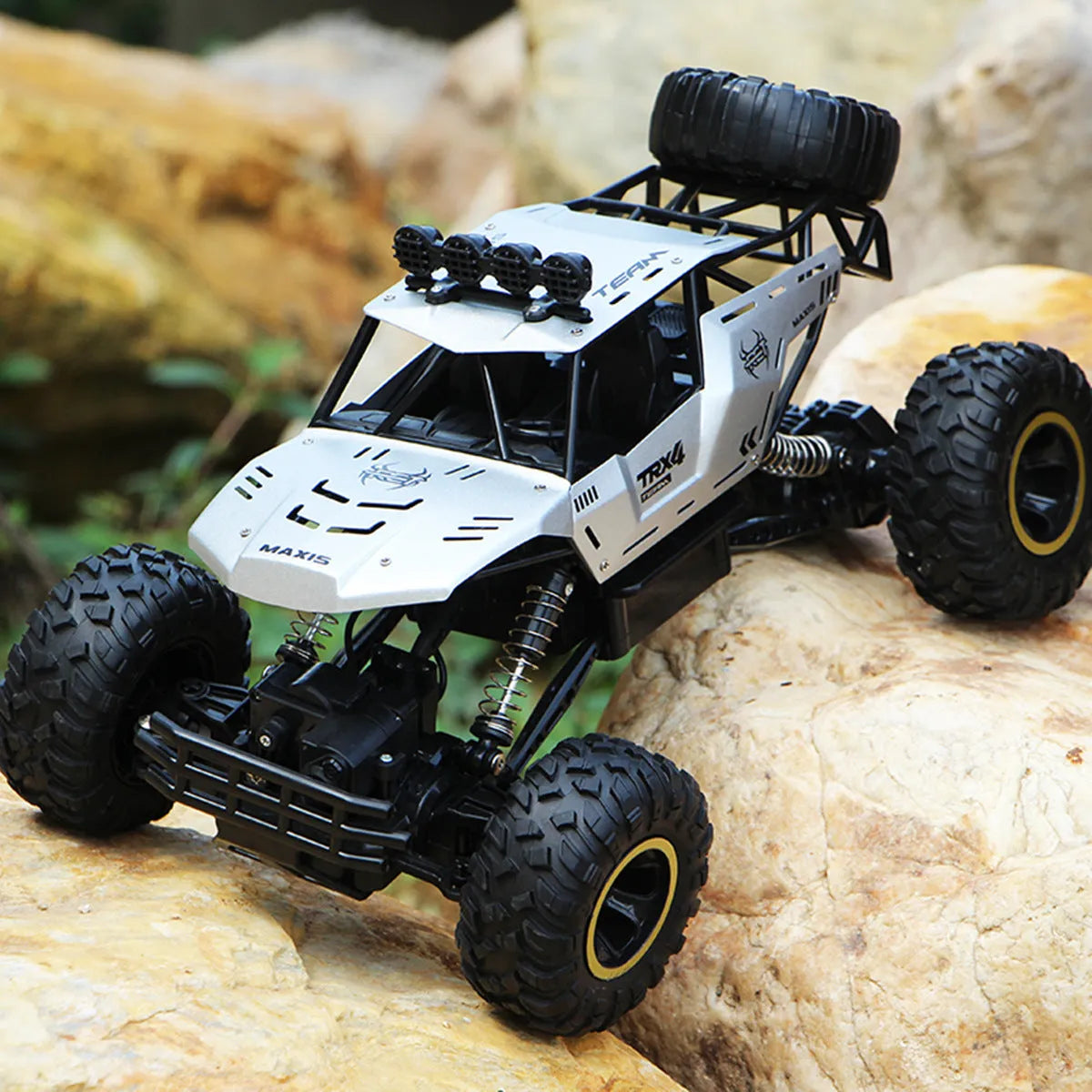 Large black 4WD remote control climbing car and a smaller silver high-speed RC car with wireless remotes