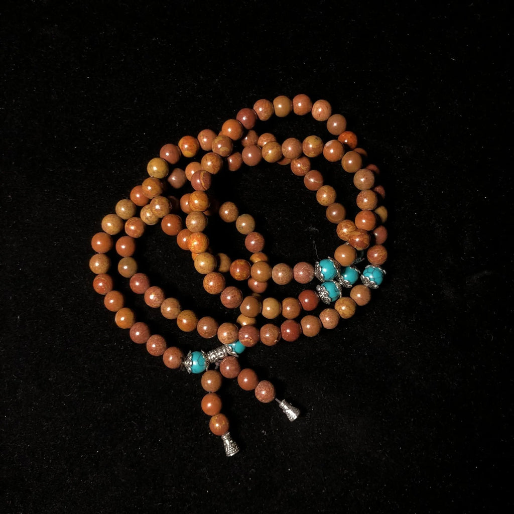 108 bead Lvzhu stone bracelet with 5-6mm geometric beads on wrist