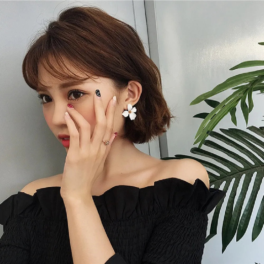 A pair of floral-shaped stud earrings for women, shown in alloy with an electroplated finish in white or pink colour.