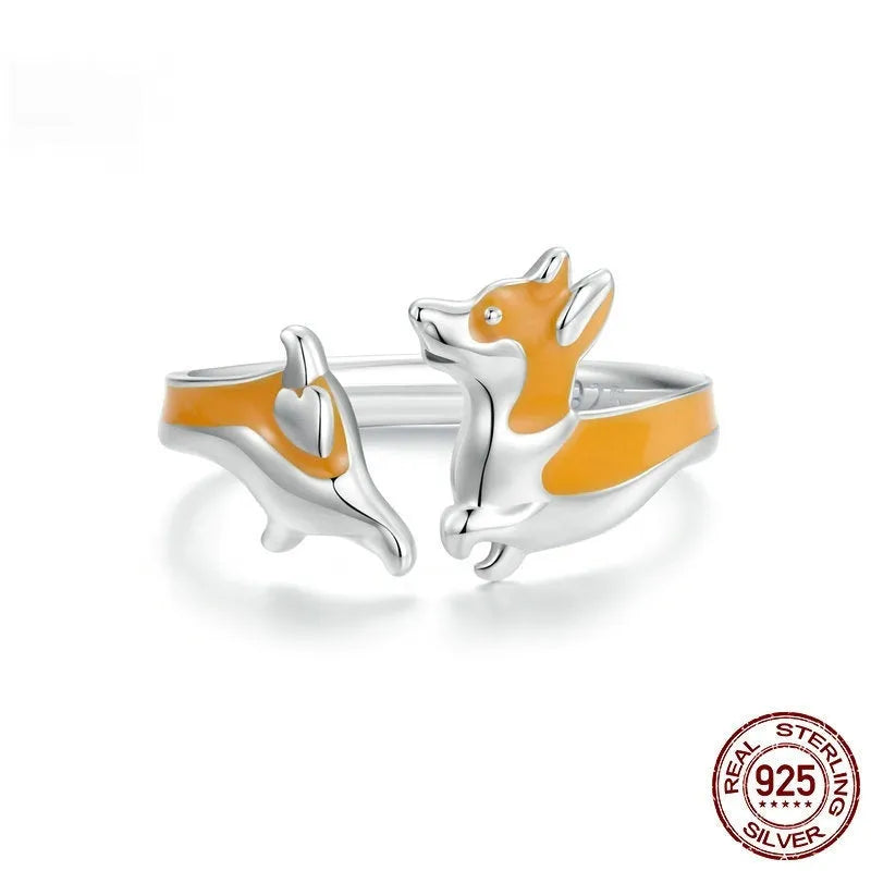 Silver corgi pet ring on a finger, showing cartoon animal design and adjustable band.