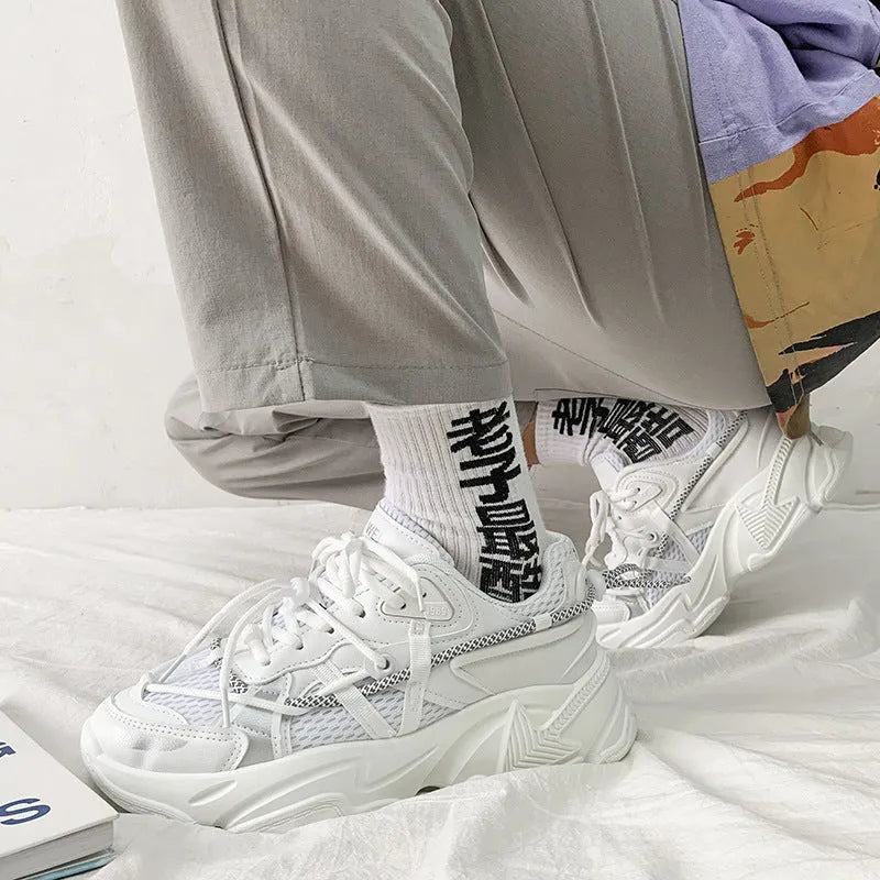 Men's white platform dad shoes with lace-up front on a neutral background.