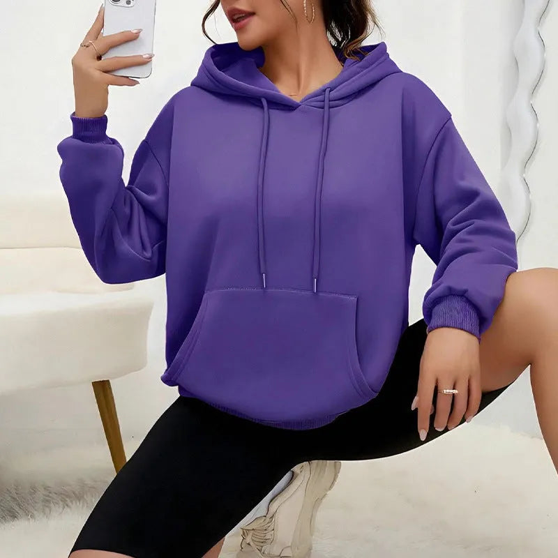 Women's loose grey drawstring hoodie with front pockets on a hanger.