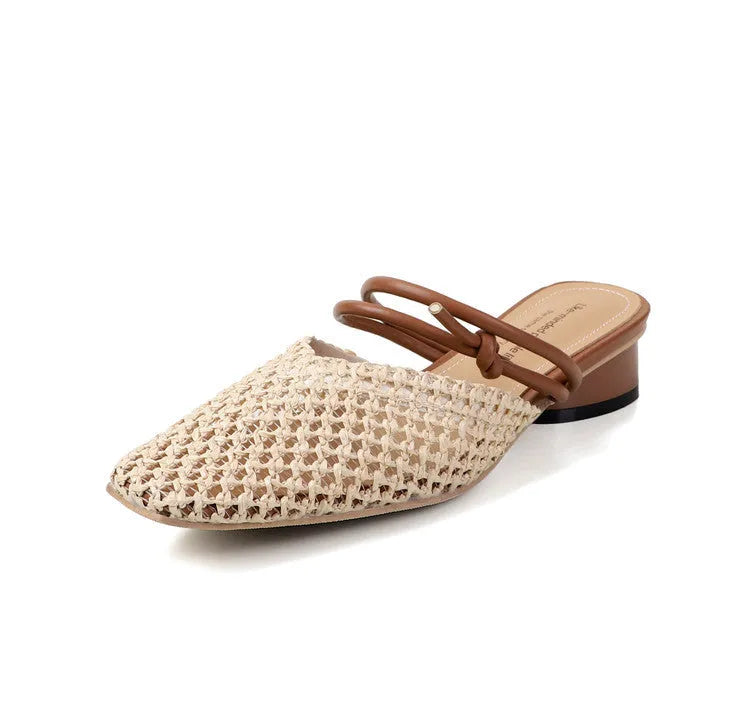 Women's black square toe slippers with hollow-out design and a chunky heel on a rubber sole.