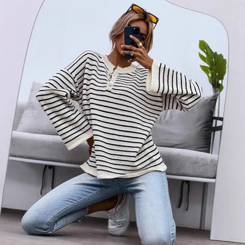 Black striped women's casual top with drop shoulders and button details on viscose knit fabric