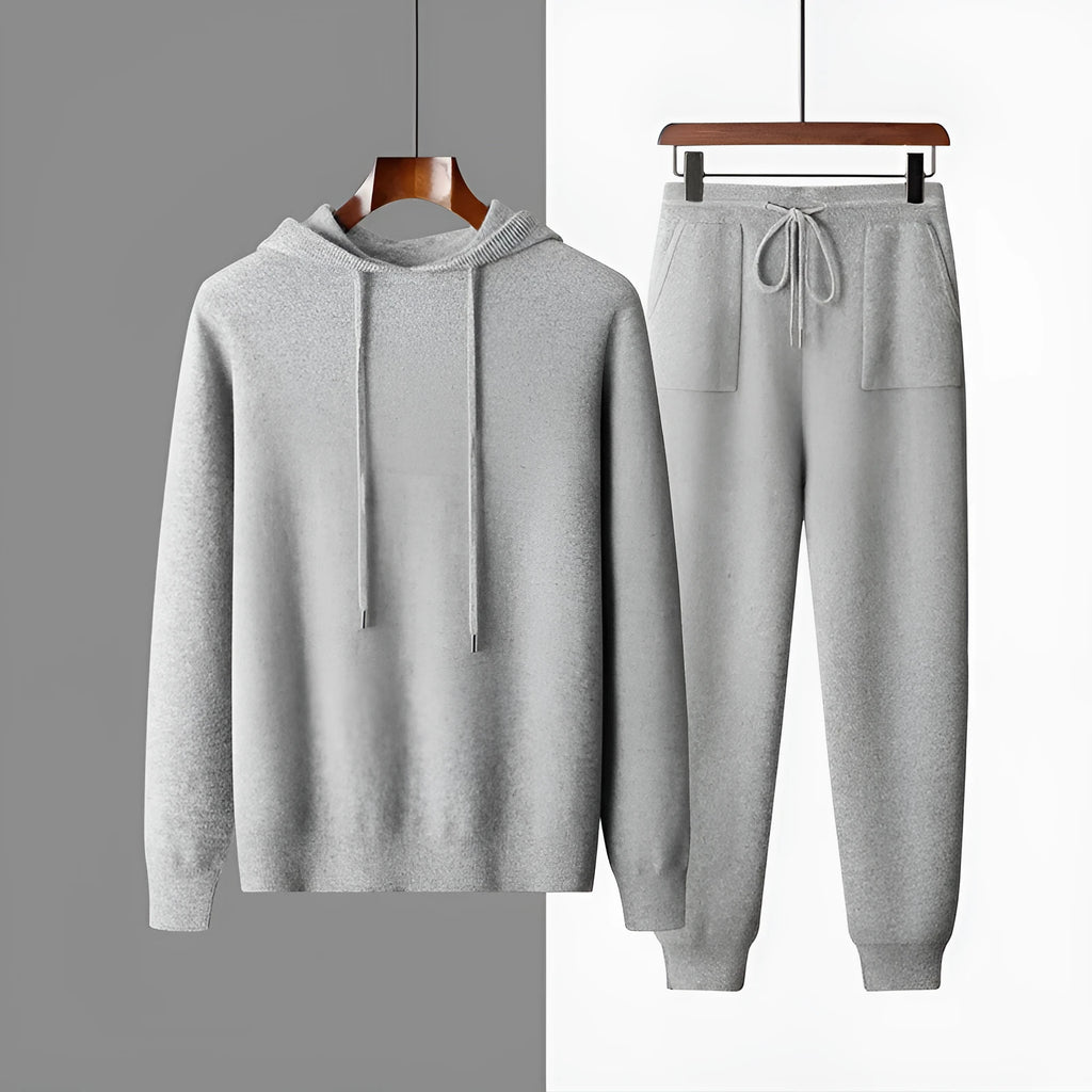 Men's light gray cashmere hoodie and matching trousers laid out as a complete casual two-piece set.