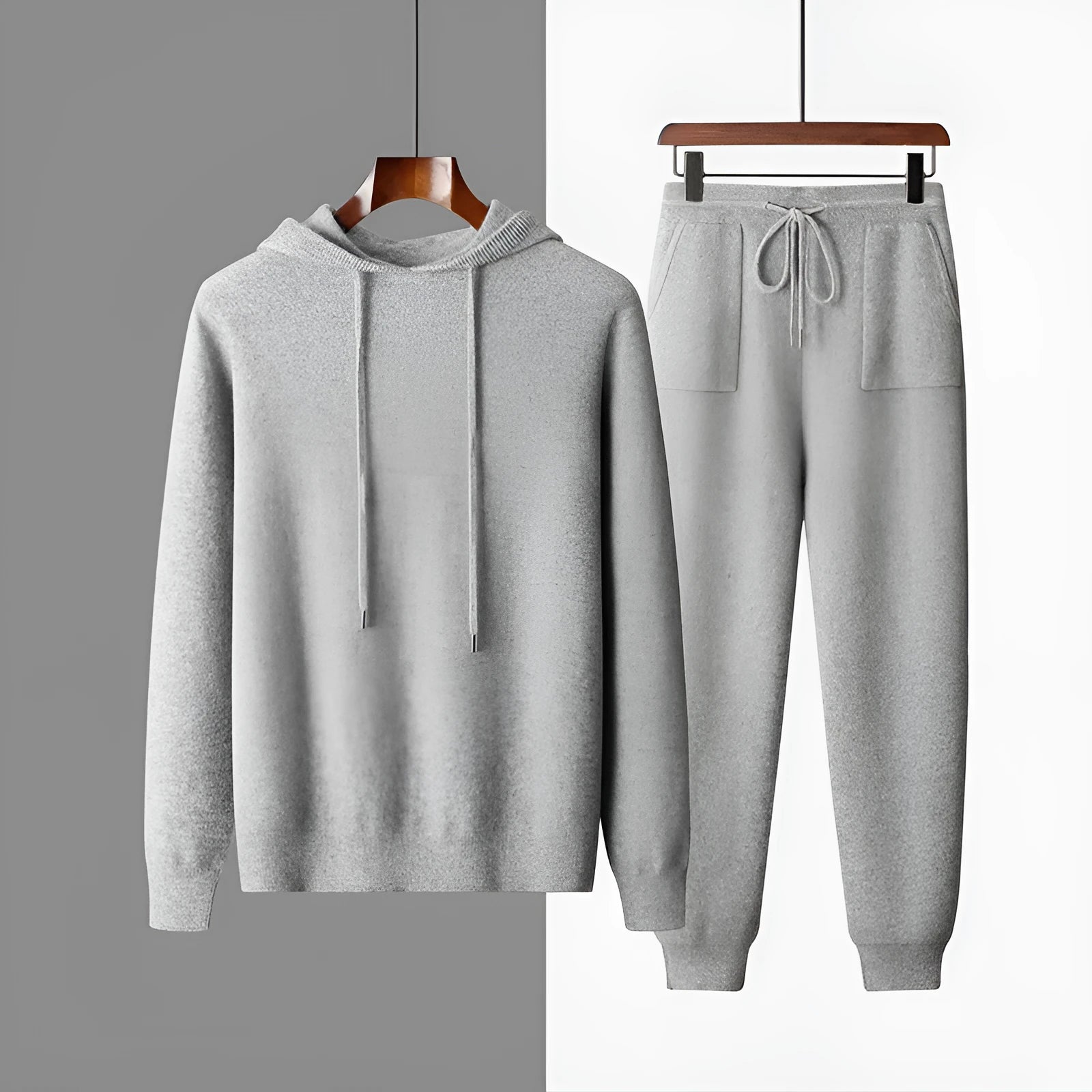 Men's light gray cashmere hoodie and matching trousers laid out as a complete casual two-piece set.