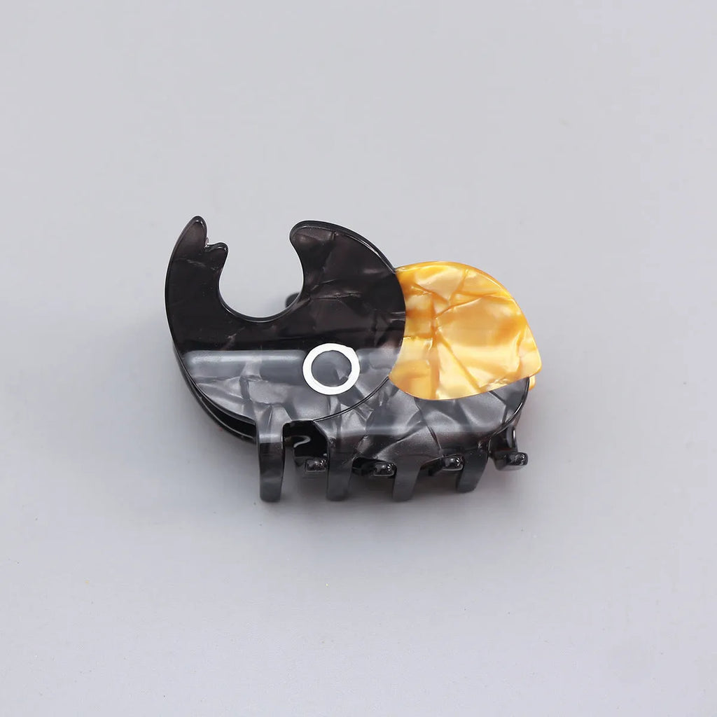 Handmade cartoon beetle grip brooch made from cellulose acetate in green, orange, or white insect designs.