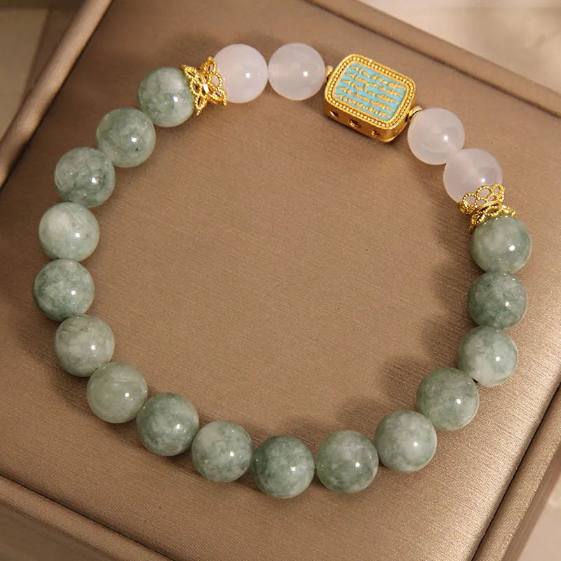 Oil green emerald crystal bracelet with five engraved Buddhist scripture beads on female wrist