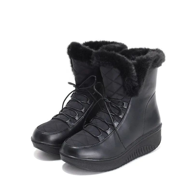 Women's black lace-up winter ankle boots with a platform sole on a white background.