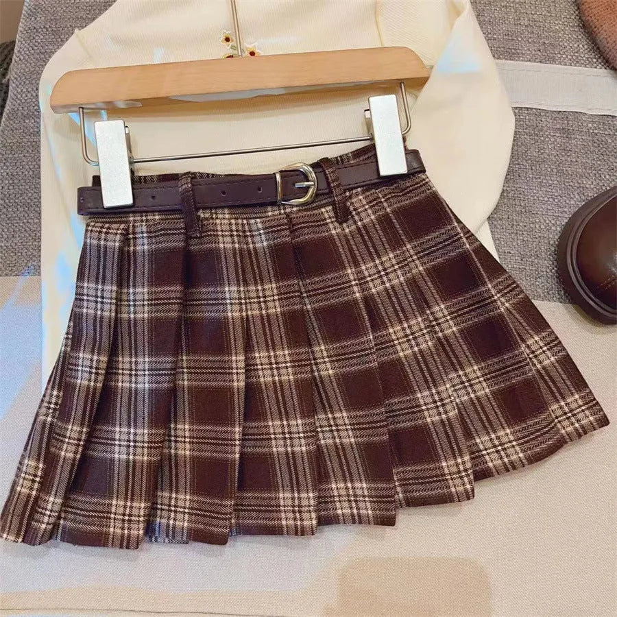Girls' cotton plaid pleated skirt in A-line style showing pleat detail and plaid pattern