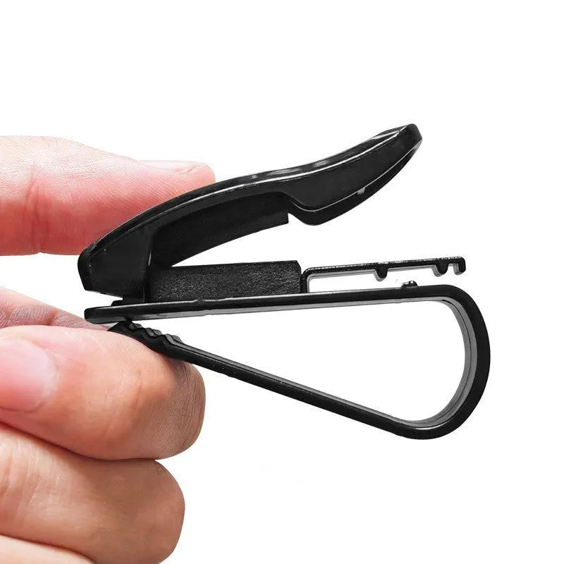 Black plastic clip for car sunshade holding sunglasses and an ID card