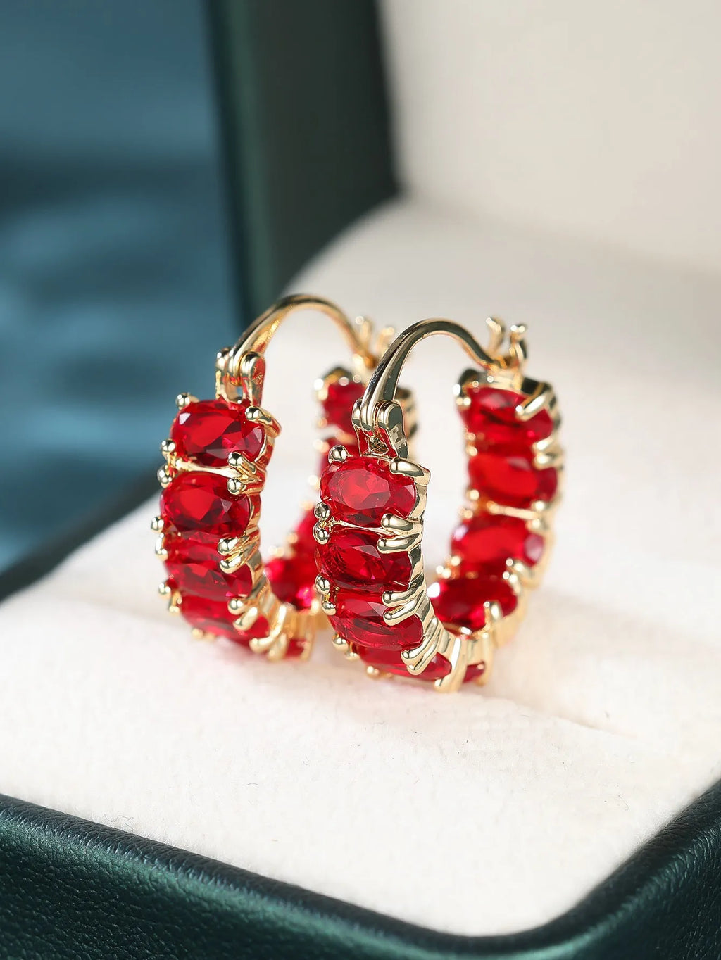 Egg-shaped ear clip earrings for women in electroplated copper, shown in platinum emerald, platinum sapphire blue and gold red