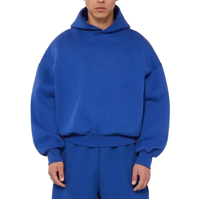 A man's grey fleece-lined pullover sweatshirt with long sleeves, shown on a hanger.