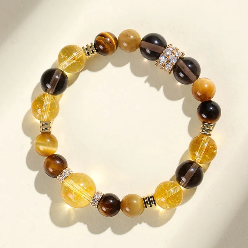 Yellow artificial crystal bracelet with 10mm Jinba large beads on a string.