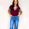 Burgundy loose knit V-neck sweater with contrast trim and cuffed short sleeves