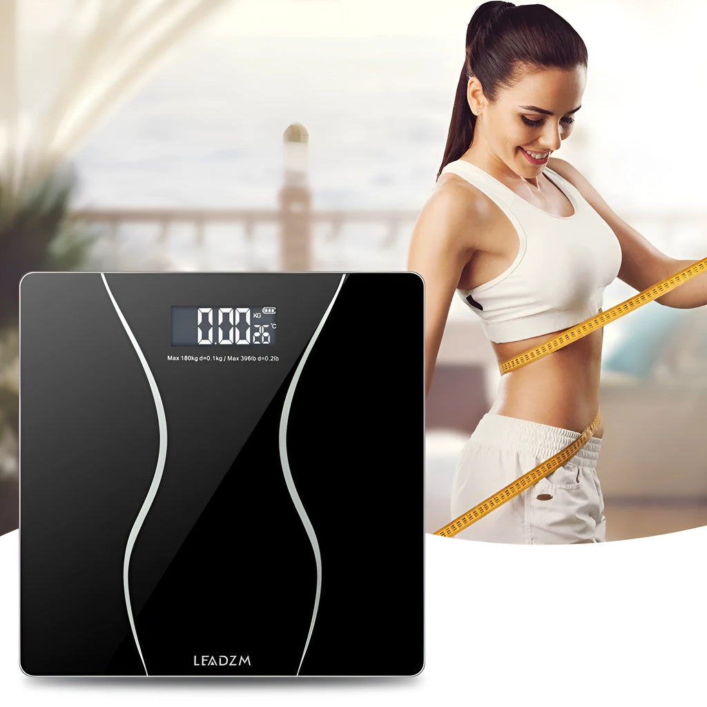 Black electronic body scale with digital display showing weight measurement up to 180KG