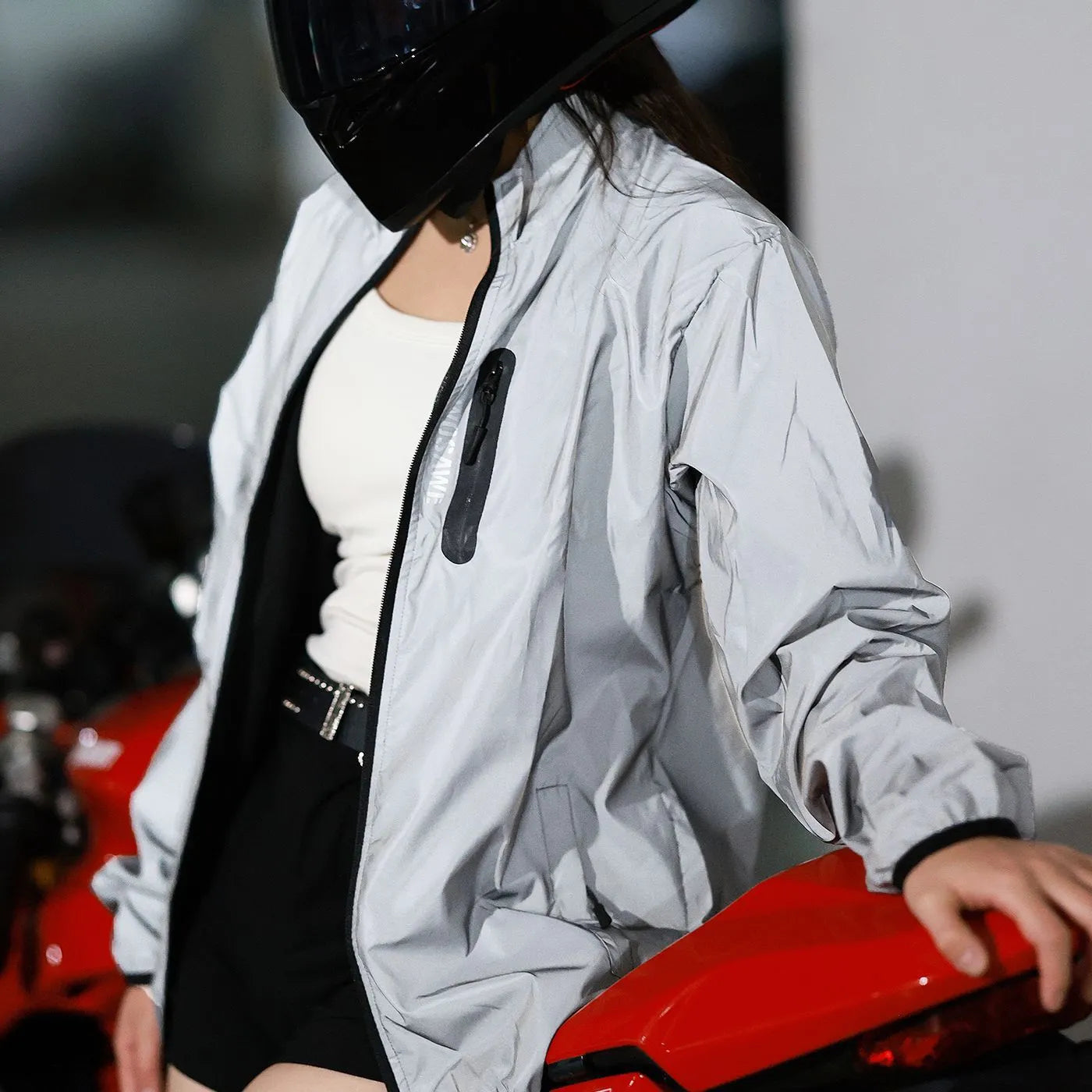 Silver waterproof polyester long sleeve top for men on a hanger.