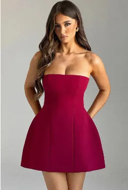 Women's backless solid colour A-line tube dress on a hanger, showing short length and high waist.