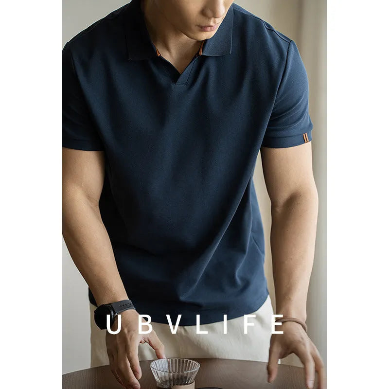 Blue short-sleeved cotton blend polo shirt on a hanger, showing regular fit and button placket.