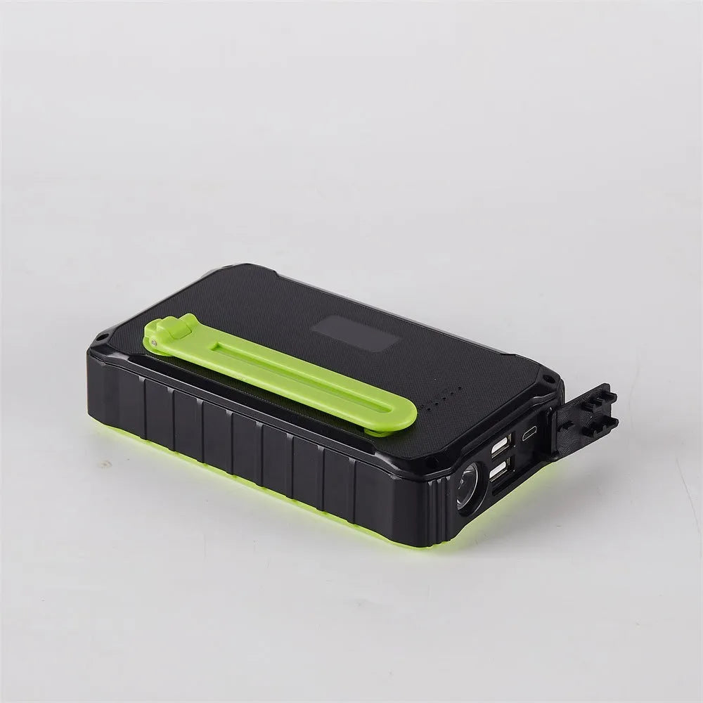Orange and green hand solar power bank with solar panel, hand crank, dual USB ports, and LED light.