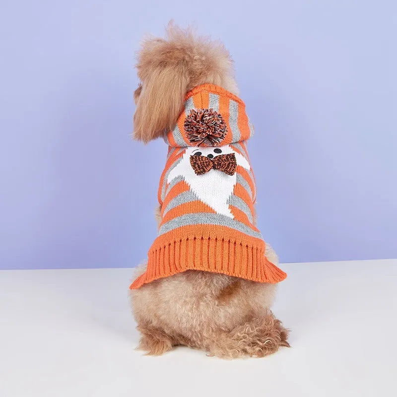 Orange knitted pet sweater with striped pattern, hood and fur balls for Halloween