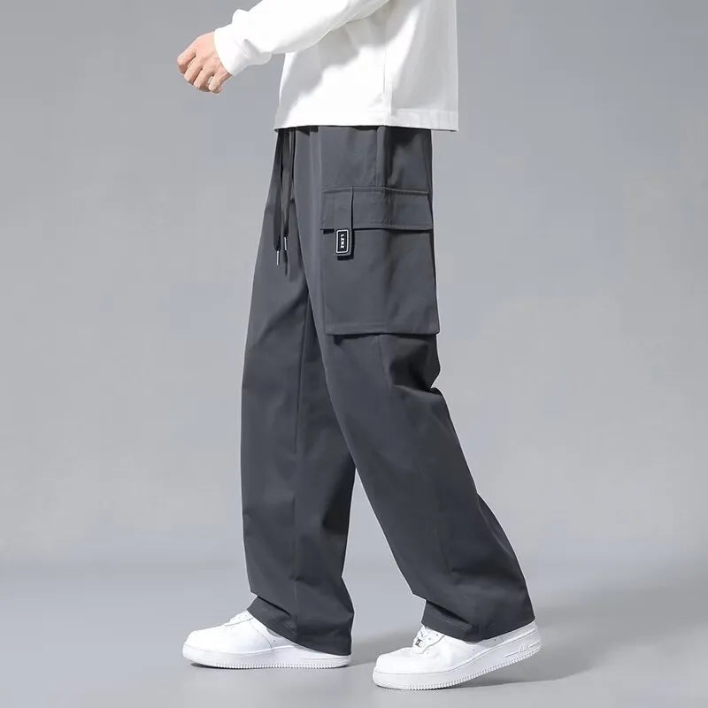 Boys in army green straight leg cargo pants with large pockets and a drawstring waist.