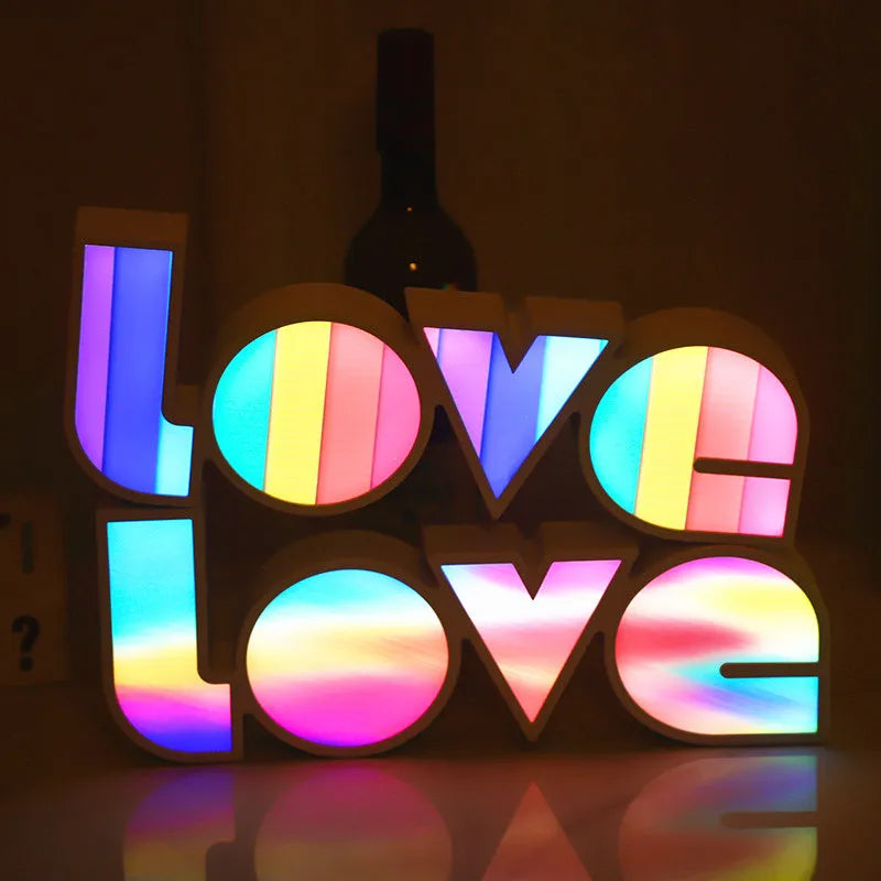 LED LOVE light with rainbow shade measuring 35.5cm, glowing softly on a wooden desk for Valentine's decoration.
