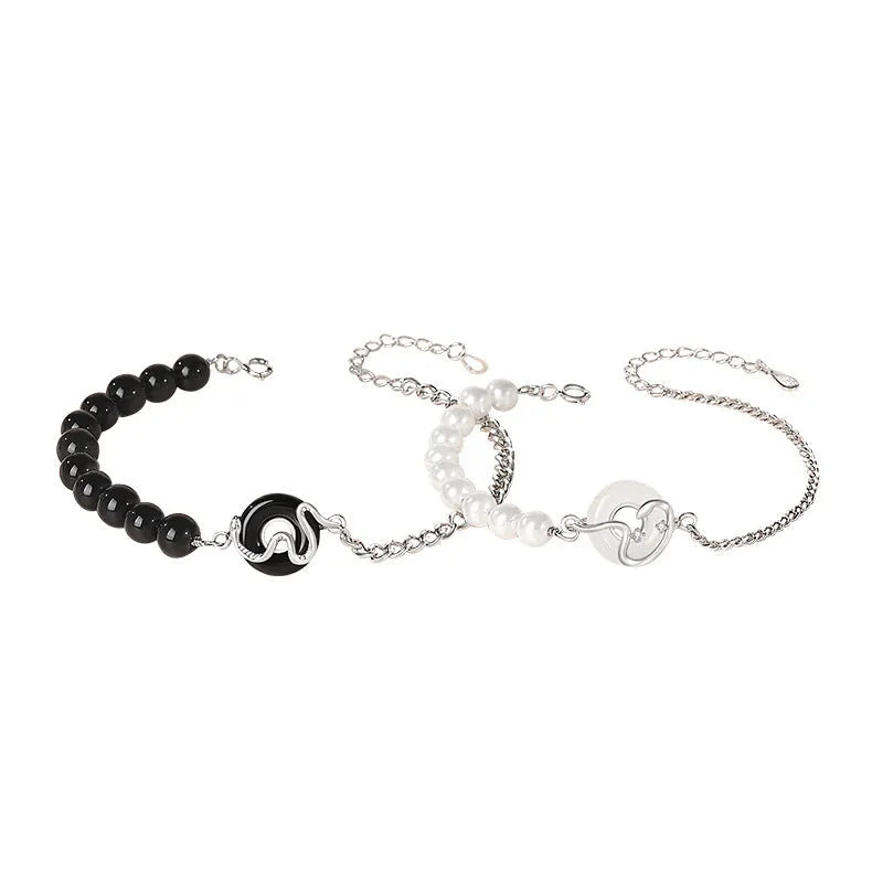 925 sterling silver couple bracelet with snake design and safety buckle on a wrist.