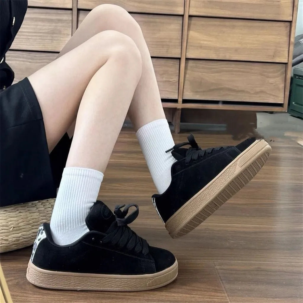 Black retro sneakers with round toe, lace-up front, and waterproof platform on rubber sole