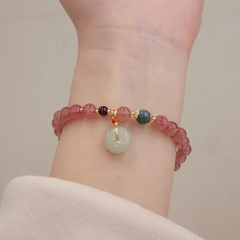 Natural strawberry quartz women's bracelet with purse charm detailing and peace buckle clasp