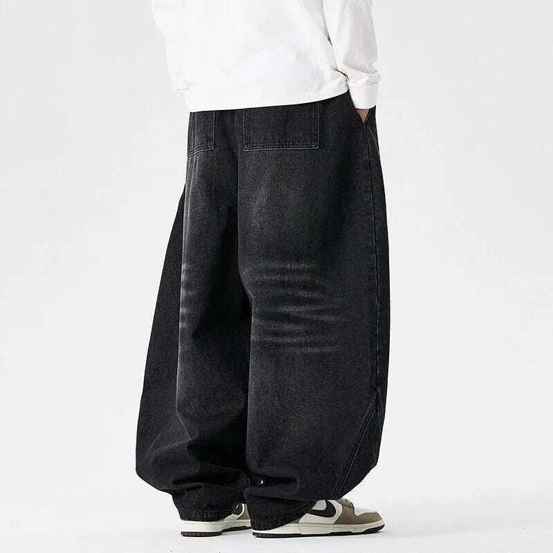 Men's plus size wide leg baggy jeans in black denim on a hanger