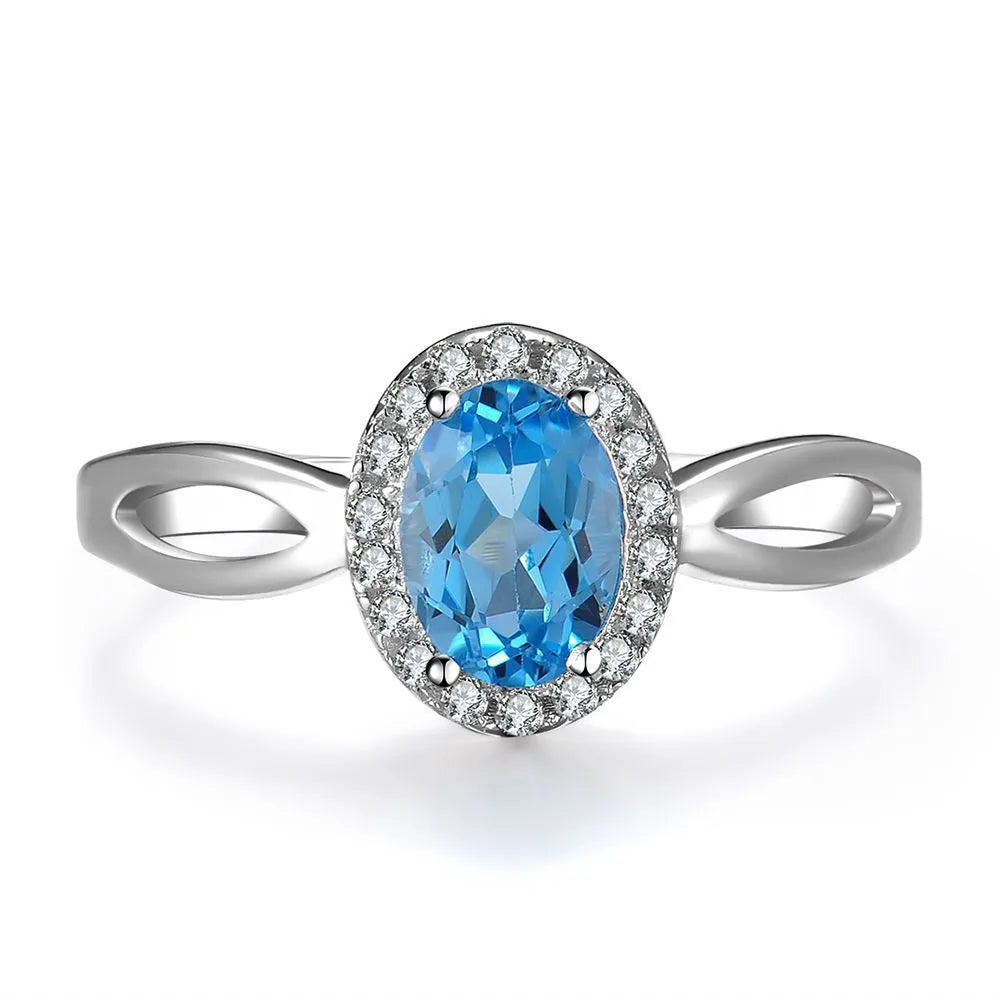 925 sterling silver jewellery set with blue topaz gemstones showing earrings, ring, pendant and necklace