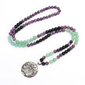 Long yoga lotus pendant necklace and matching bracelet set with stone beads and geometric design.