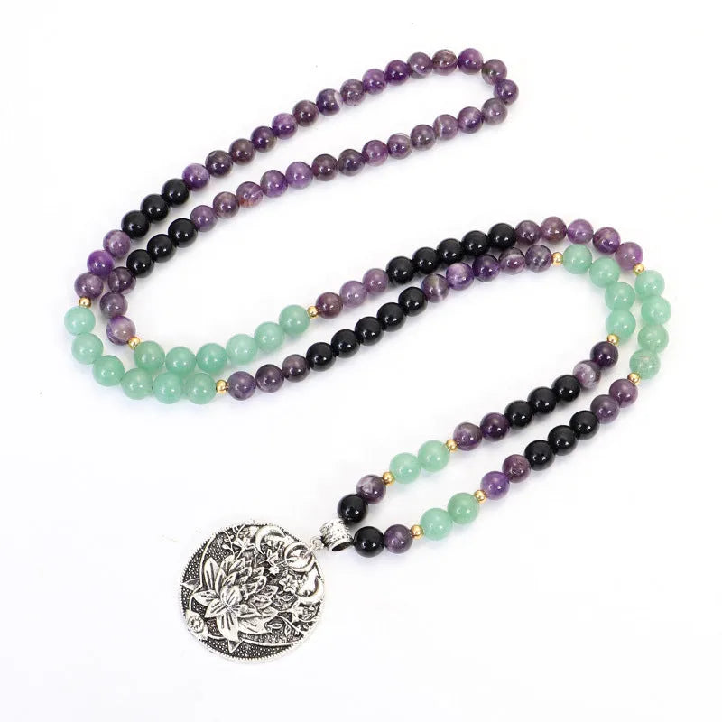 Long yoga lotus pendant necklace and matching bracelet set with stone beads and geometric design.
