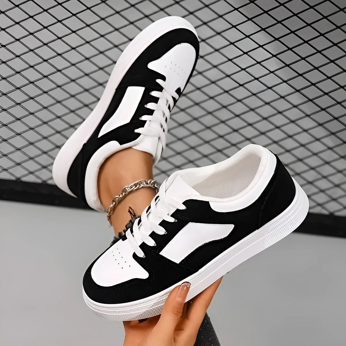 Black women's casual sports shoes with round toe, lace-up front, and flat rubber sole.