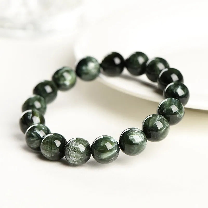 Green Dragon Crystal bracelet with round beads and a central Ruyi knot on a wrist.