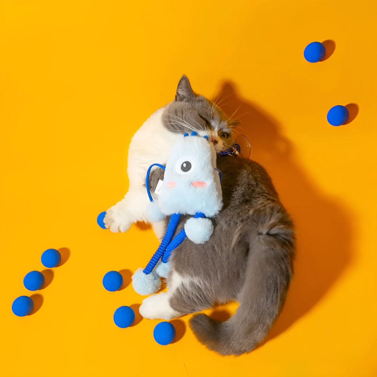 Blue telescopic elastic cat toy with plush element and mint-scented bell ring extended during play